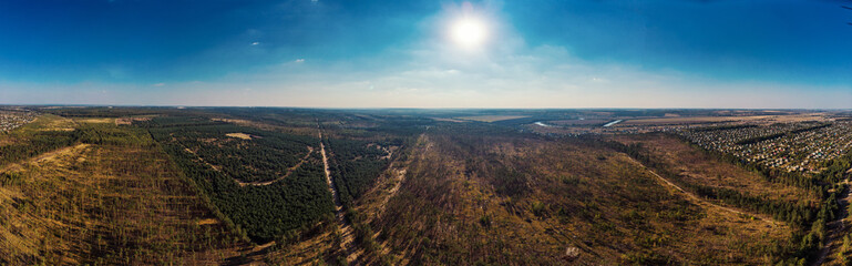 Aerial panorama view from above of nature landscape with forest and rural countryside with houses, beautiful scenery landmark