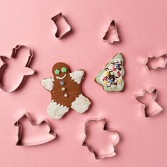 Metal forms for Christmas cookies on pink background. Top view. Flat lay. Trendy colorful photo. Minimal style with colorful paper backdrop. Christmas concept