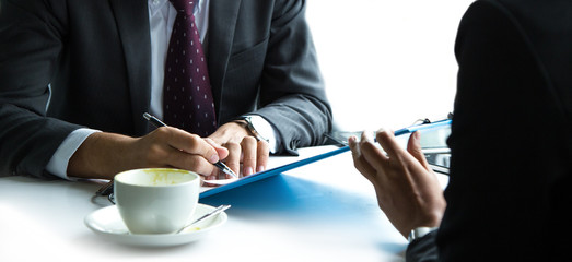 Fototapeta premium Businessmen and business women are meeting and using a tablet.