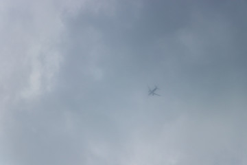 a passenger plane disappearing in the clouds