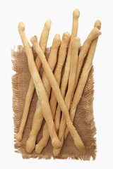 Bread sticks on burlap. isolate white background