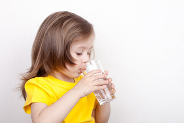 Portrait of girl drinking glass of water