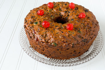 Homemade fruitcake on a glass platter.