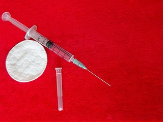 Medicine Medical Health Industry Transparent Plastic Syringe For Drugs Medicament Vaccine Injection Tool And White Cotton Circles On The Red Textile Cloth Velvet Background 