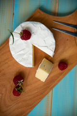 cheese camembert with a fork for cheese and grape