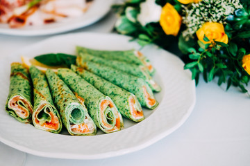 Spinach pancakes stuffed with salmon fish and cheese