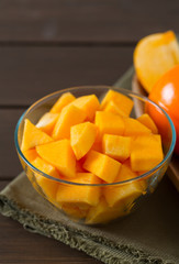 cut persimmon on wooden surface