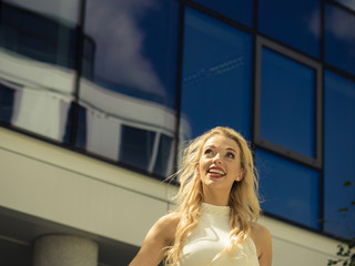 Cheerful fashionable woman in city