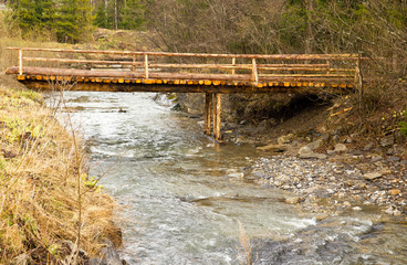 Wooden bridge over a mountain stream