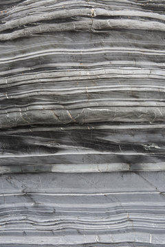 A textured background image of the layers of slate and marble that have been compressed together over millions of years in the cross section of a geological rock formation