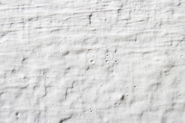 Decorative plaster effect on wall. white plaster lighted by daylight.