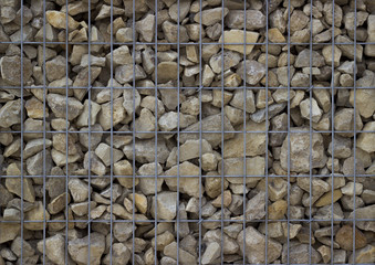 Stone wall of a gabion as a background. A popular element of design for a garden