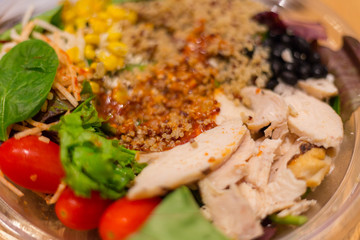 Chicken Salad with spinach, Cherry tomatoes, corn salad, baby spinach, fresh mint and basil. Home made food. Concept for a tasty and healthy meal. Dark stone background. Top view. Close up.