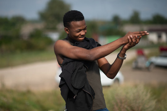 Confident cool African guy, imitating the firing of finger