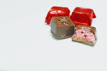 Homemade chocolate candies filled with strawberry and white chocolate.