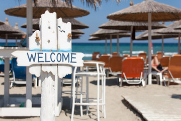 Welcome sign at beach bar