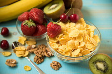 Tasty cornflakes with walnut in glass bowl