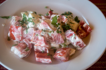 Fresh vegetable salad with sour cream.