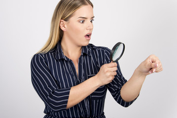 beautiful girl checking her skin with magnifier size plus model  body skin care concept with...