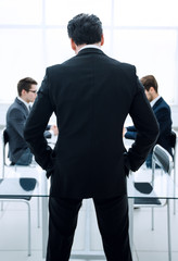 Fototapeta premium rear view.businessman standing in the conference room