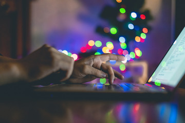 close up young man working on a laptop at night at home workplace f