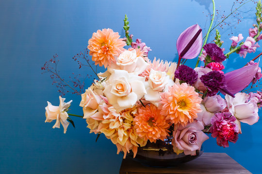 Background with bouquet of pink in glass vase on blue background. Bouquet of chrysanthemums as decoration.