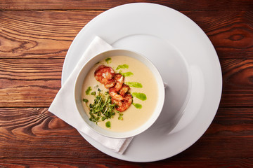 Creamy cheese soup with grilled shrimps