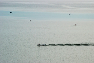 Caravan of boats is driven across the lake