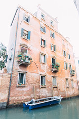 Fototapeta na wymiar Ancient bulding in Venice. Canal and boat. Italy
