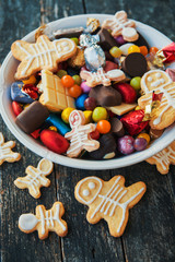 Happy Halloween card. Funny delicious ginger cookie shape ghost and skeleton, Halloween Jack o Lantern candy bowl  