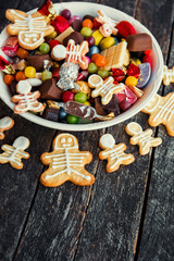 Happy Halloween card. Funny delicious ginger cookie shape ghost and skeleton, Halloween Jack o Lantern candy bowl  