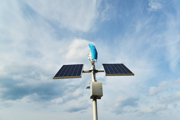 Obraz premium Solar panels and a small wind generator for the production of environmentally friendly energy