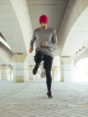 Young man jumping on pathway in park