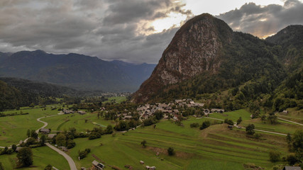 Aerial view of village Srednja Vas near the Bohinj lake in Slovenia. Village surrounded with forest and highest mountains in Slovenia. Part of national park Triglav.