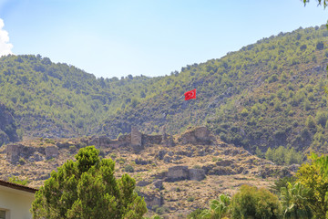 Fethiye castel view from city with turkish flag in Fethiye, Turkey