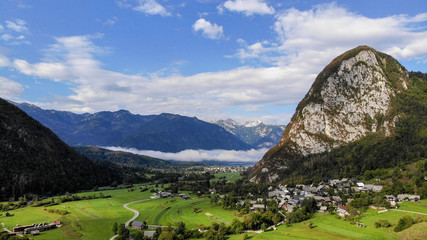 Aerial view of village Srednja Vas near the Bohinj lake in Slovenia. Village surrounded with forest and highest mountains in Slovenia. Part of national park Triglav.