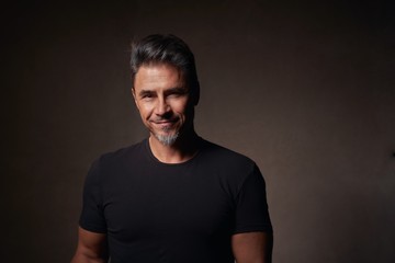 Portrait of an older white guy dark background