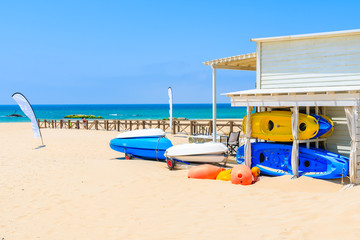 Colorful kayaks on sandy Tarifa beach, Andalusia, Spain