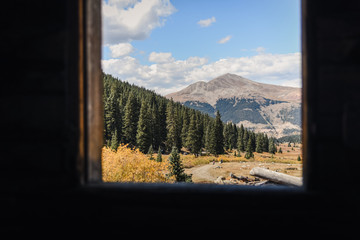 A Colorado, mountain landscape seen from the inside abandoned mining ruins. 