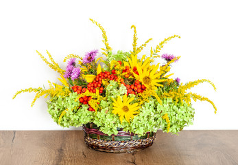 Summer flower arrangement in a basket. Table decoration.