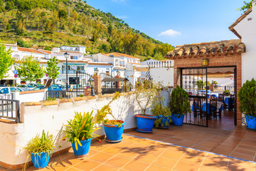 Terrace with flowerpots and white houses in picturesque village of Mijas, Andalusia. Spain © pkazmierczak