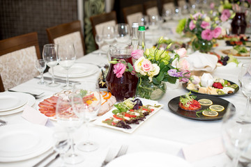 Served for a banquet table. Wine glasses with napkins, glasses and salads