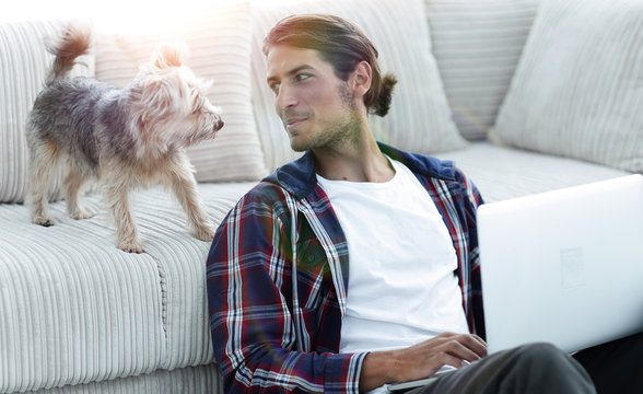 successful guy and his pet in a cozy living room.