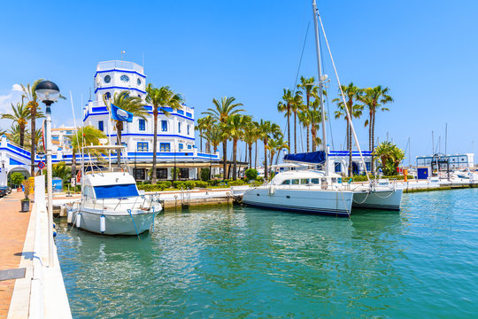 Boats and beautiful lighthouse building in Estepona port on Costa del Sol coast, Spain