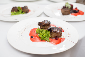 fried beef steaks with spices, on a white table