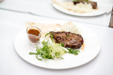 fried beef steaks with spices, on a white table