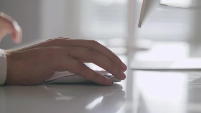 Close-up of male hands using computer mouse