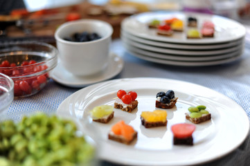 Party food. Mini cakes with berry mousse, caramel and fresh berries.