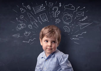 Smart little kid in front of a drawn up blackboard ruminate