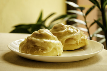 Two rolls, a cake on a coffee table in a cafe.